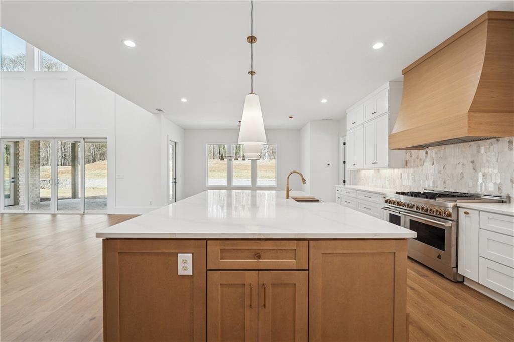 3315 Bold Springs Road Dacula, GA 30019 - Photo 55 of 63 a kitchen with stainless steel appliances granite countertop a sink a stove a refrigerator and a oven with wooden floor