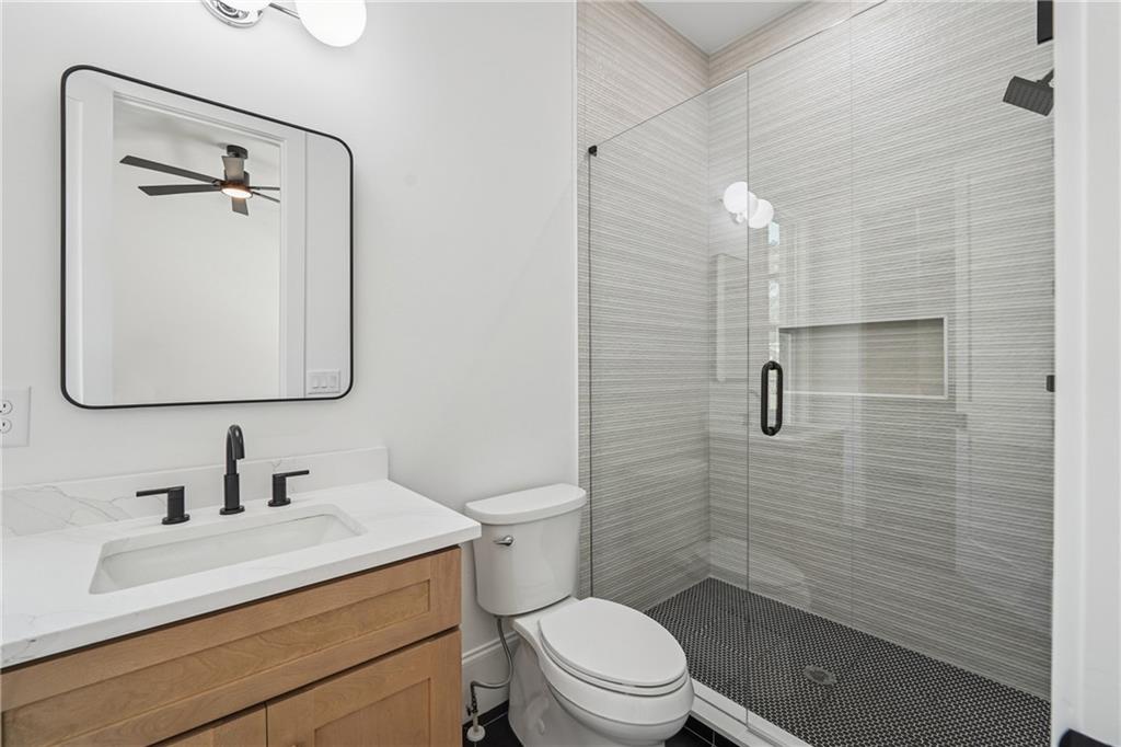3315 Bold Springs Road Dacula, GA 30019 - Photo 58 of 63 a bathroom with a sink a toilet and shower