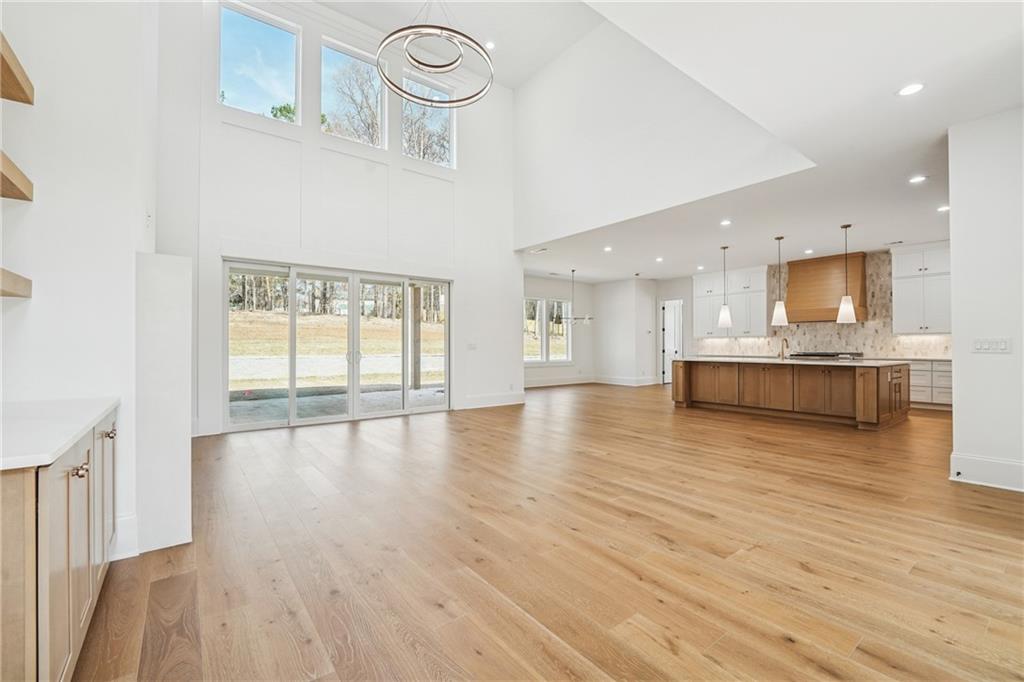3315 Bold Springs Road Dacula, GA 30019 - Photo 7 of 63 a view of a kitchen and an empty room with wooden floor