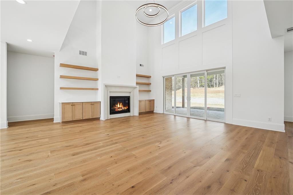 3315 Bold Springs Road Dacula, GA 30019 - Photo 8 of 63 an empty room with wooden floor fireplace and window