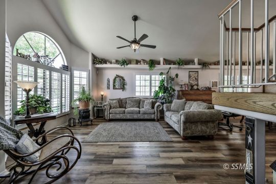 1213 Andrea Court Ridgecrest, CA 93555 - Photo 2 of 50 a living room with furniture a fireplace and a floor to ceiling window