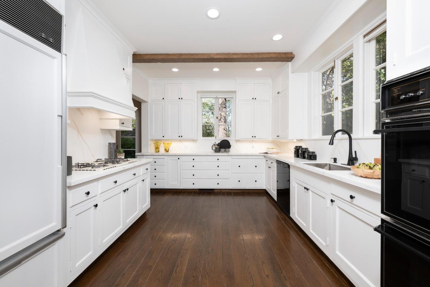 841 Hayne Road Hillsborough, CA 94010 - Photo 30 of 78 a large kitchen with a lot of counter space and wooden floor