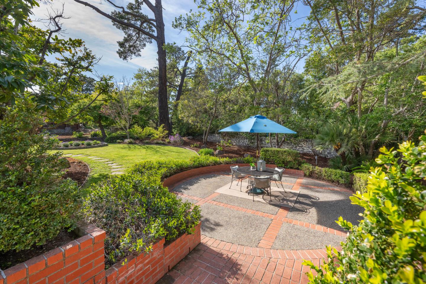 841 Hayne Road Hillsborough, CA 94010 - Photo 52 of 78 a view of a patio with table and chairs under an umbrella with large trees