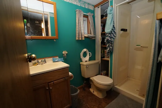 a bedroom with a bed gym equipment and view of living room