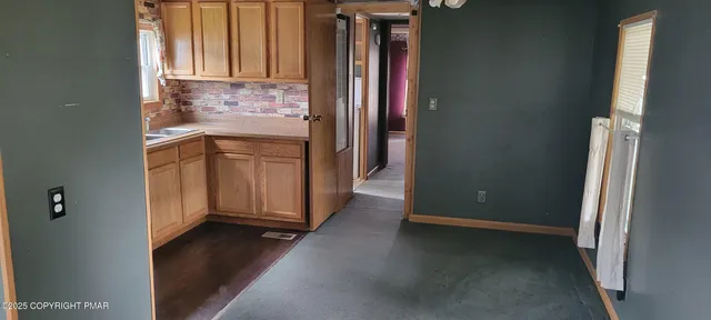 a kitchen with a stove a refrigerator and a sink