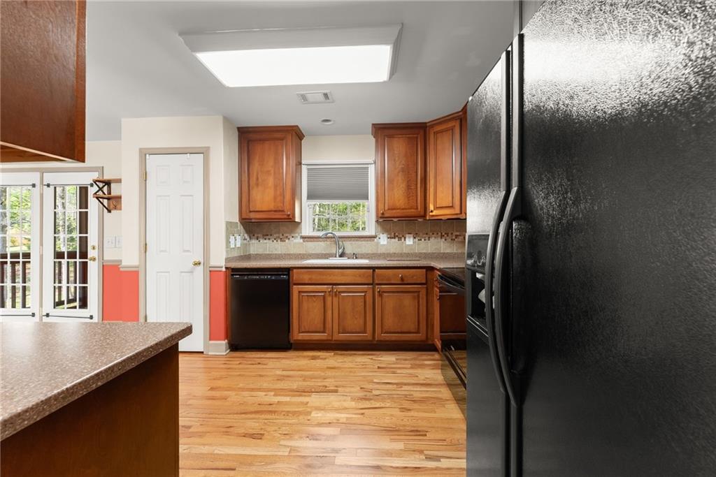 3454 Highway 254 Cleveland, GA 30528 - Photo 12 of 52 a kitchen with stainless steel appliances granite countertop a refrigerator a sink dishwasher a stove and a dining table next to a window
