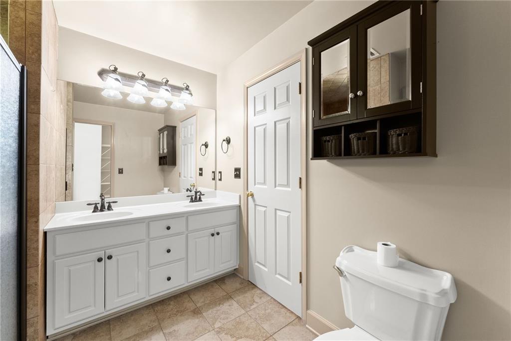 3454 Highway 254 Cleveland, GA 30528 - Photo 20 of 52 a bathroom with a double vanity sink a toilet and a mirror