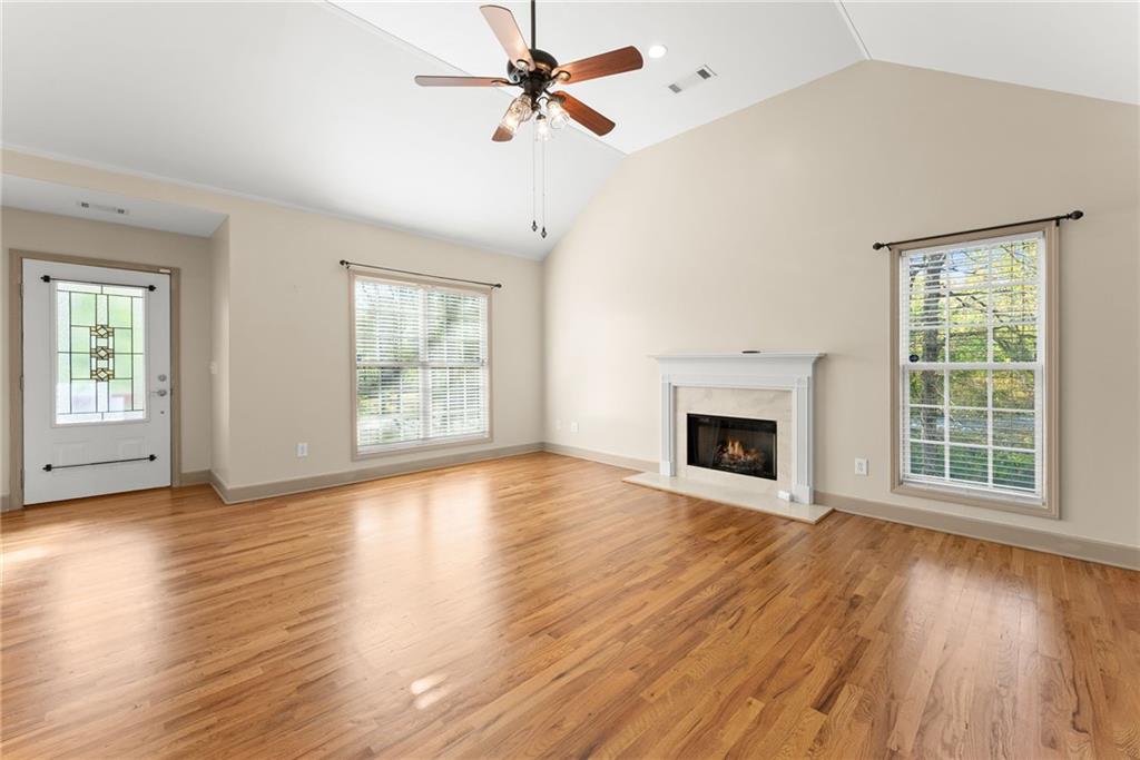 3454 Highway 254 Cleveland, GA 30528 - Photo 5 of 52 a view of an empty room with wooden floor fireplace and a window