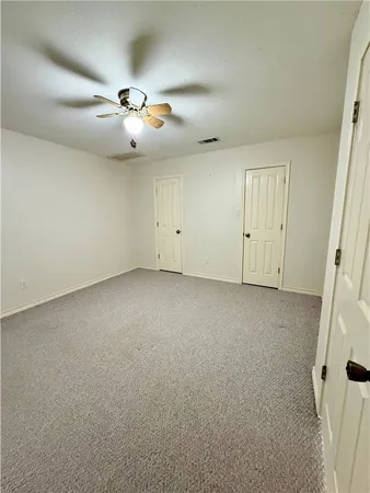 an empty room with a empty space and ceiling fan