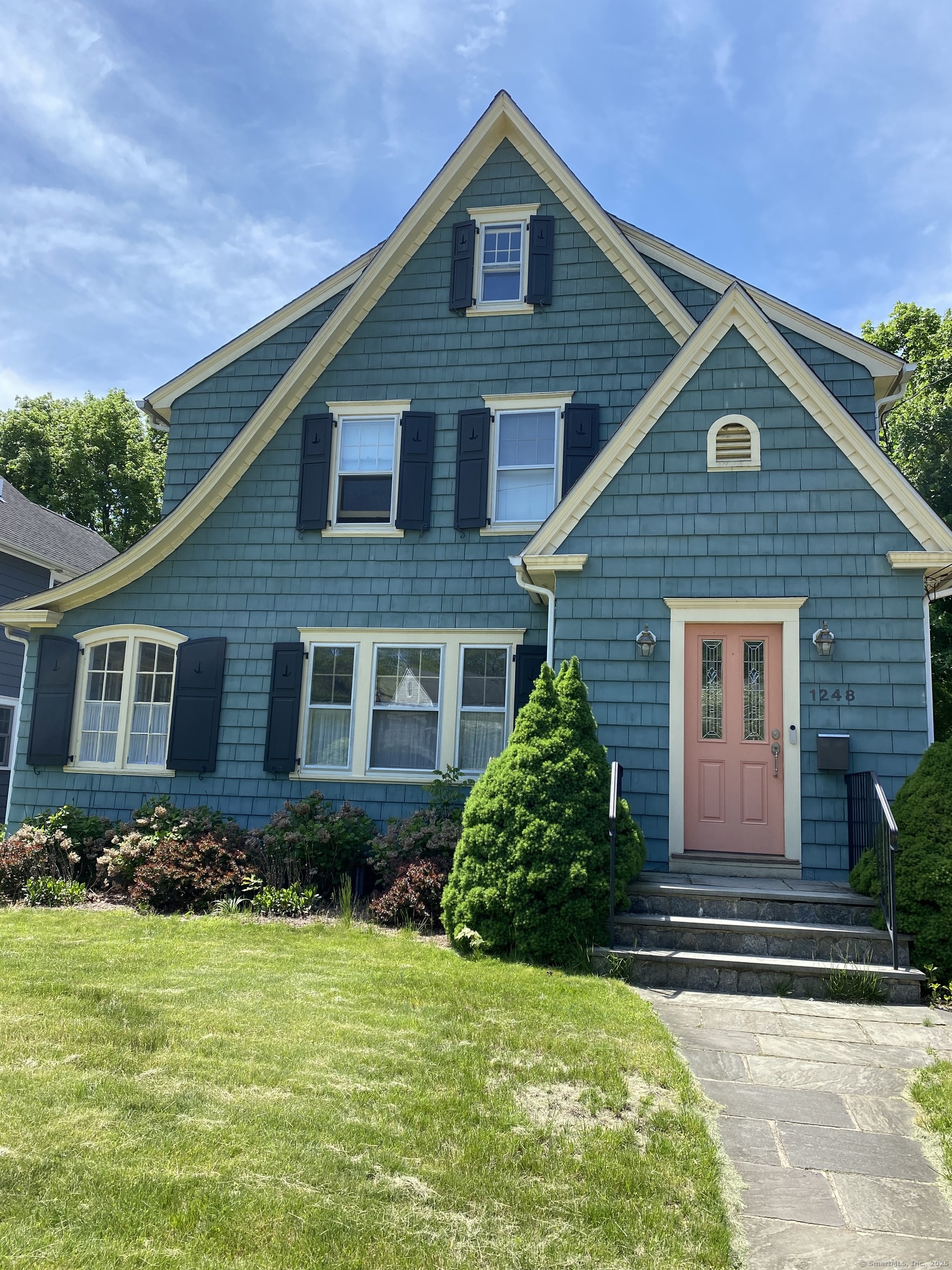 a front view of a house with garden