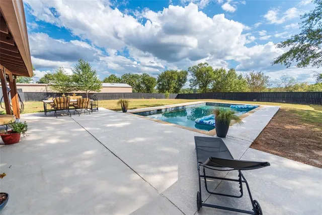 a view of swimming pool with lounge chair