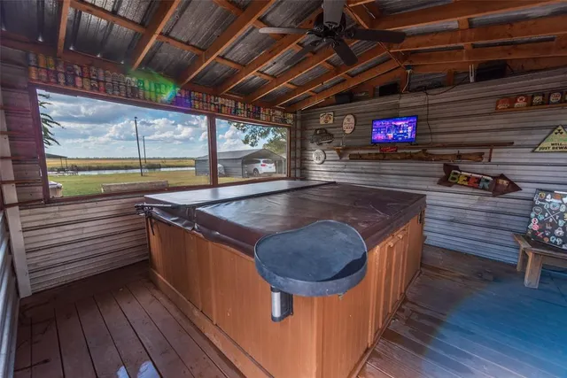 a view of outdoor space with wooden floor and flat screen tv