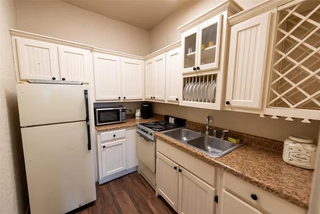 a kitchen with a refrigerator and a sink