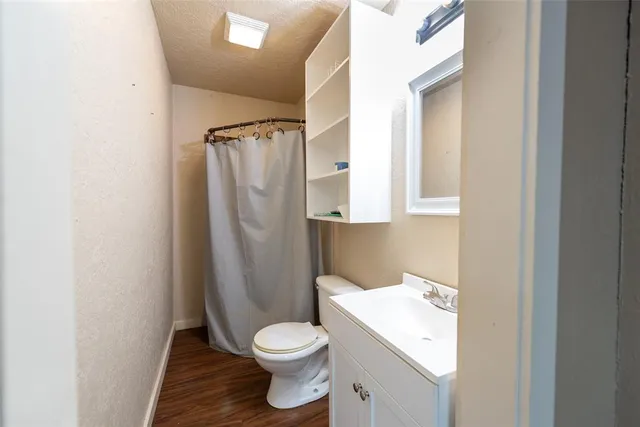 a white toilet sitting next to a bathroom sink