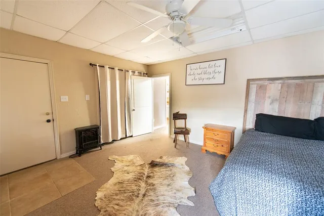 a spacious bedroom with a bed and a couch