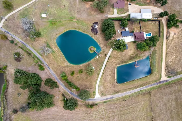 an aerial view of a house with a yard and sitting area