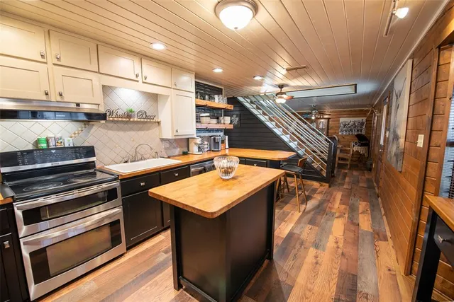 a kitchen with a sink and stove top oven