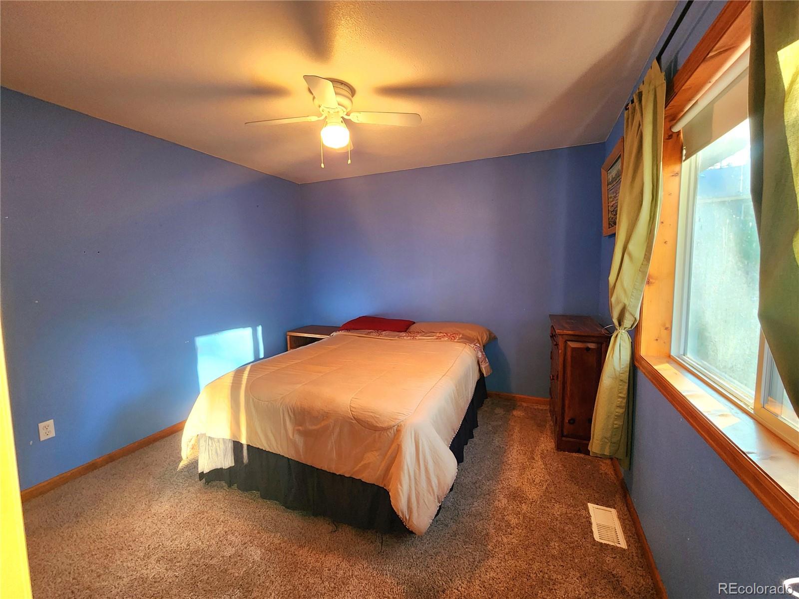 493 Caesar Road Black Hawk, CO 80422 - Photo 20 of 35 a bed sitting in a bedroom next to a window
