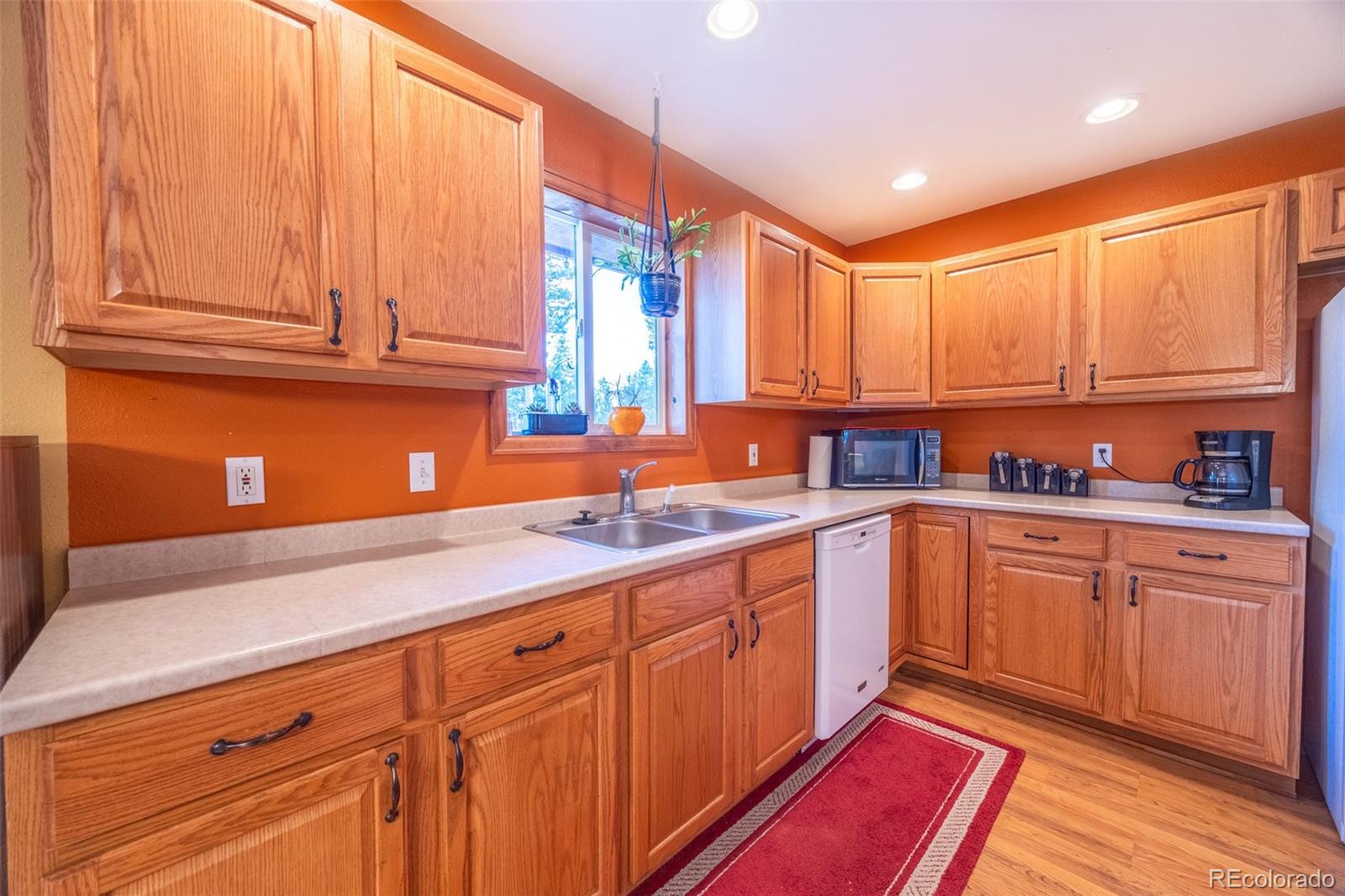 493 Caesar Road Black Hawk, CO 80422 - Photo 7 of 35 a kitchen with stainless steel appliances granite countertop a sink and cabinets
