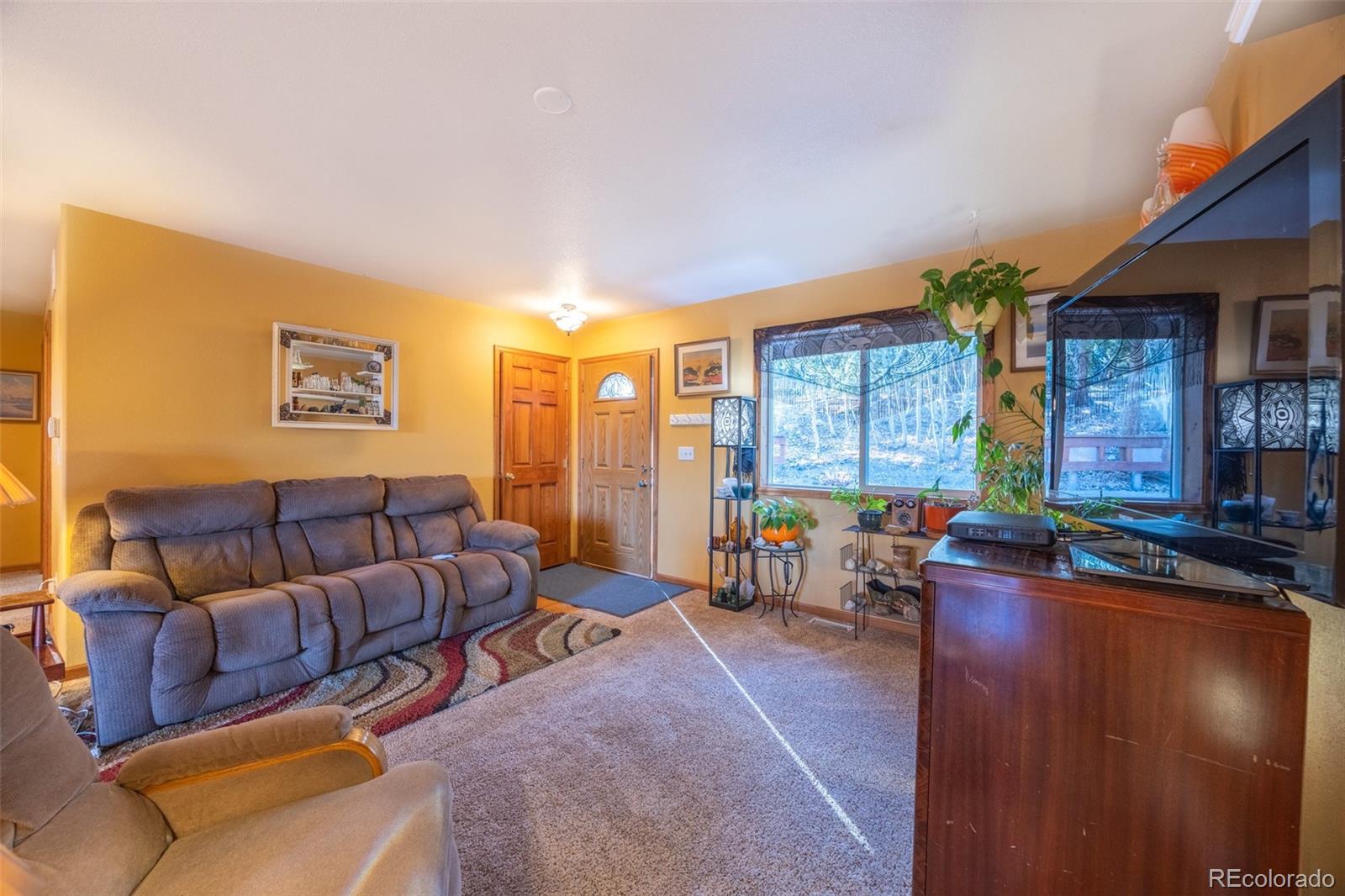 493 Caesar Road Black Hawk, CO 80422 - Photo 9 of 35 a living room with furniture and a large window