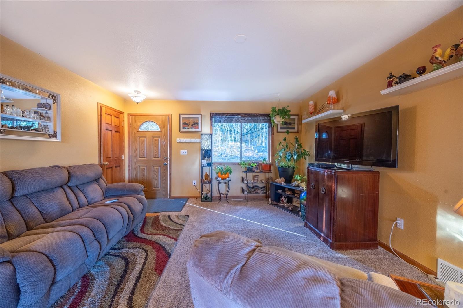 493 Caesar Road Black Hawk, CO 80422 - Photo 10 of 35 a living room with furniture and a flat screen tv