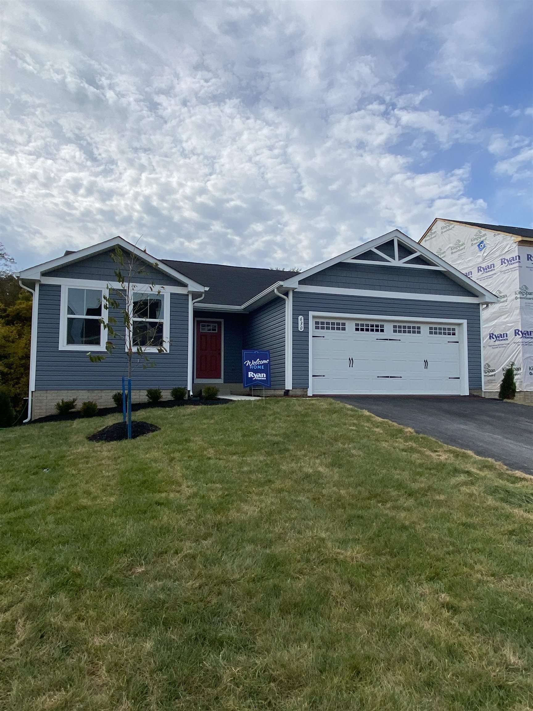a front view of a house with a garden