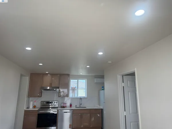 a kitchen with stainless steel appliances a sink a stove a refrigerator and cabinets