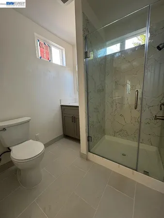 a bathroom with a toilet and a shower