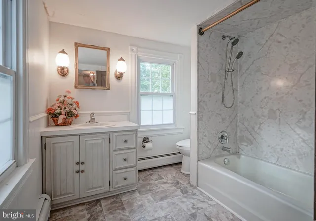 an empty room with wooden floor and closet area