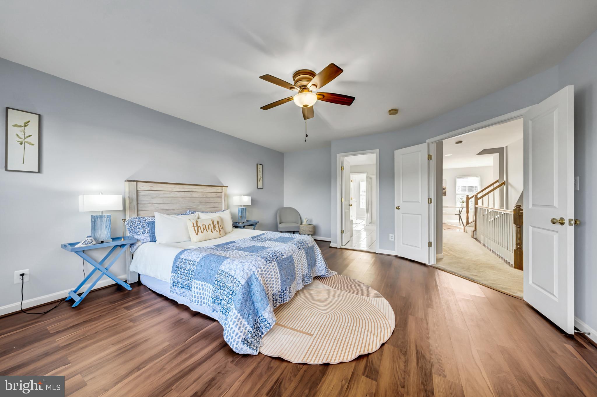 9231 Ribbon Falls Loop Bristow, VA 20136 - Photo 21 of 40 a bedroom with a bed and wooden floor