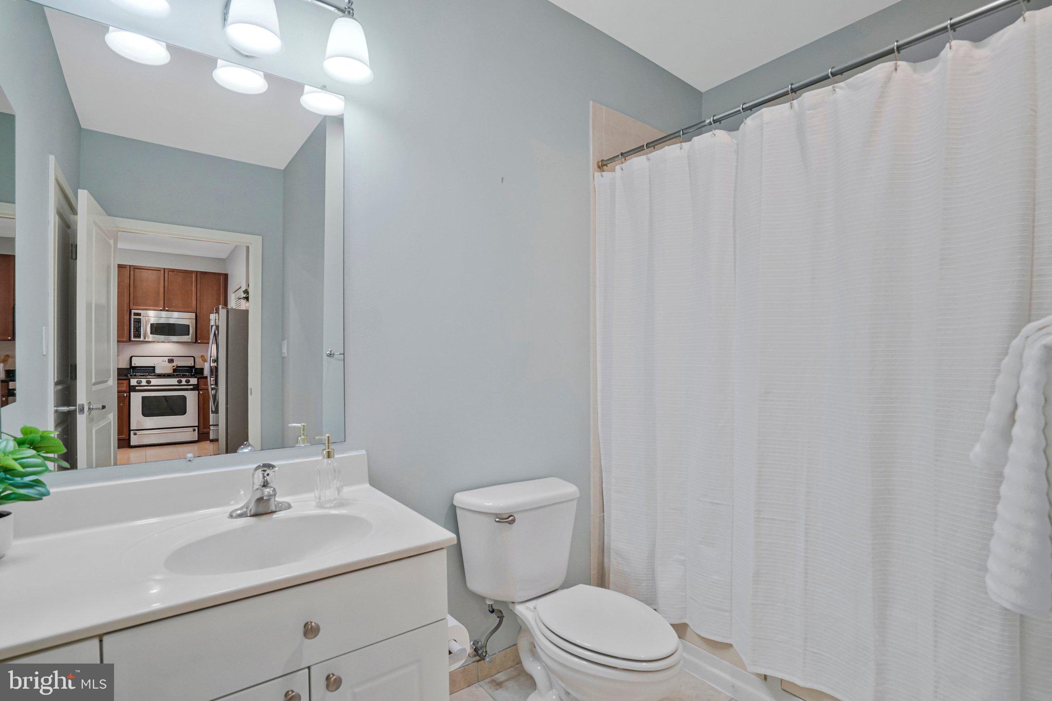 181 East Reed Avenue, Unit 206 Alexandria, VA 22305 - Photo 12 of 37 a bathroom with a sink vanity mirror and toilet