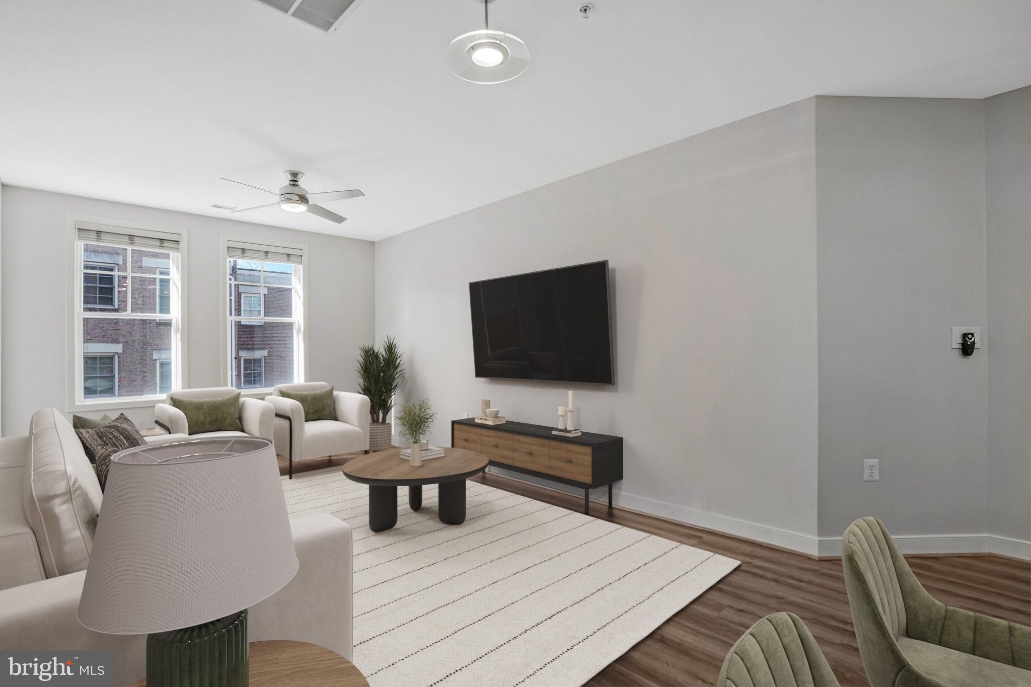 181 East Reed Avenue, Unit 206 Alexandria, VA 22305 - Photo 4 of 37 a living room with furniture and a flat screen tv