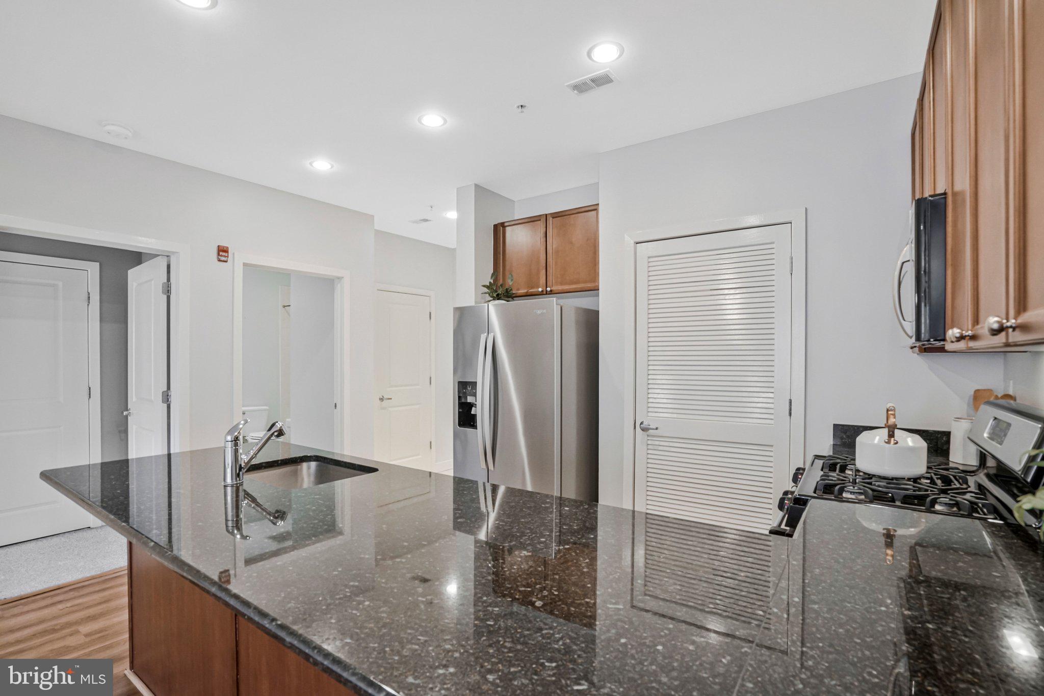 181 East Reed Avenue, Unit 206 Alexandria, VA 22305 - Photo 6 of 37 a kitchen with refrigerator and window