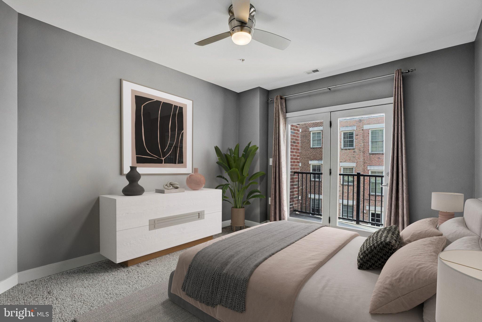 181 East Reed Avenue, Unit 206 Alexandria, VA 22305 - Photo 8 of 37 a bedroom with a bed and a chandelier