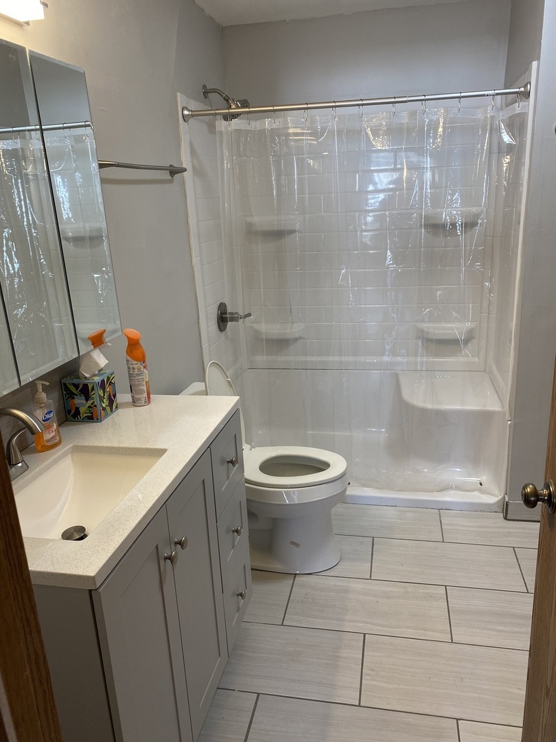 893 Golf Course Road, Unit 1 Crystal Lake, IL 60014 - Photo 8 of 9 a bathroom with a sink a toilet and shower