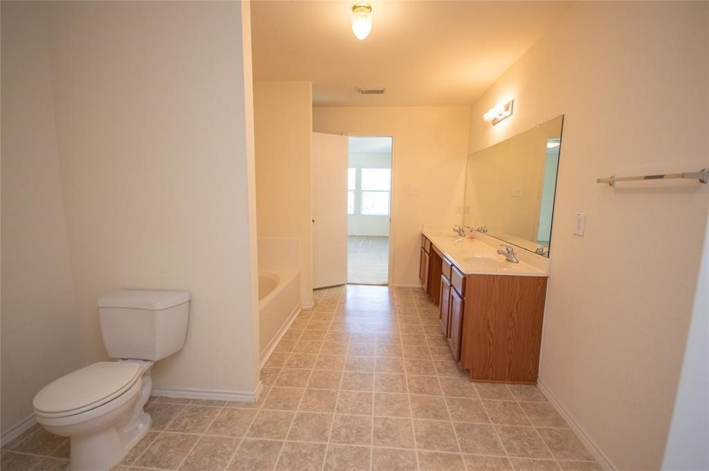 310 Falling Pine Drive Conroe, TX 77304 - Photo 11 of 15 a bathroom with a sink a toilet and shower
