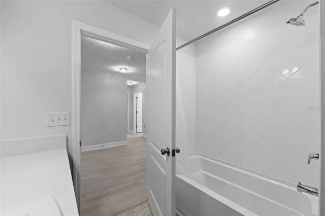 a bedroom with a large bed and a potted plant