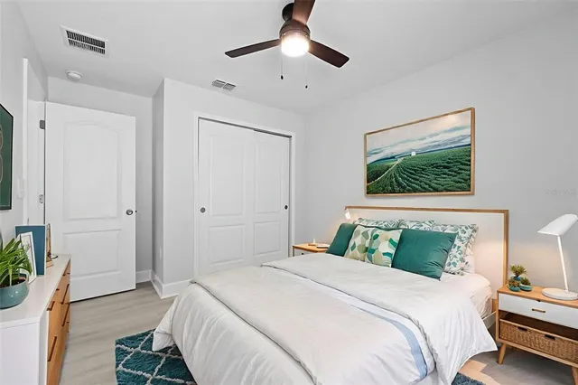 a bedroom with a bed and a chandelier