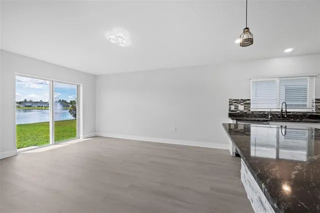 a view of a kitchen with a stove cabinets and a ceiling fan