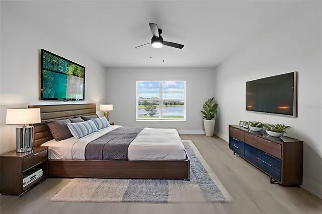 an aerial view of a city with lots of residential buildings and mountain view in back