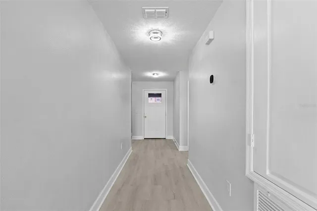 a bedroom with a bed and a potted plant