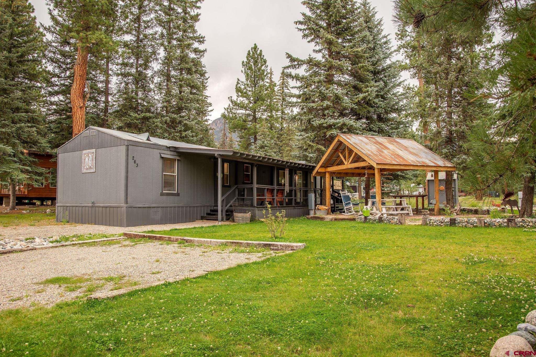 263 Mountain River Drive Bayfield, CO 81122 - Photo 16 of 21 a front view of a house with swimming pool having outdoor seating