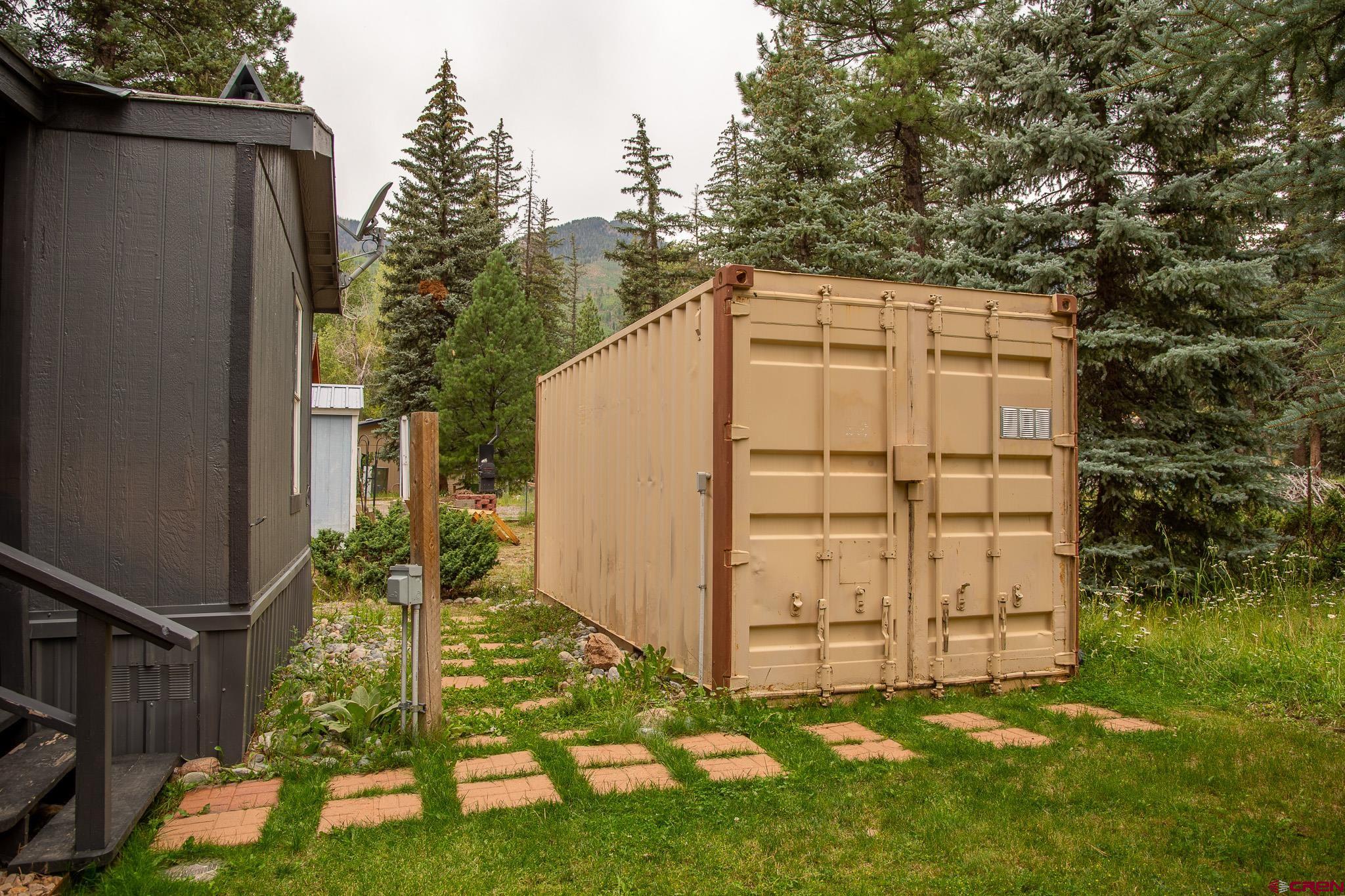 263 Mountain River Drive Bayfield, CO 81122 - Photo 17 of 21 a backyard of a house with plants and large tree