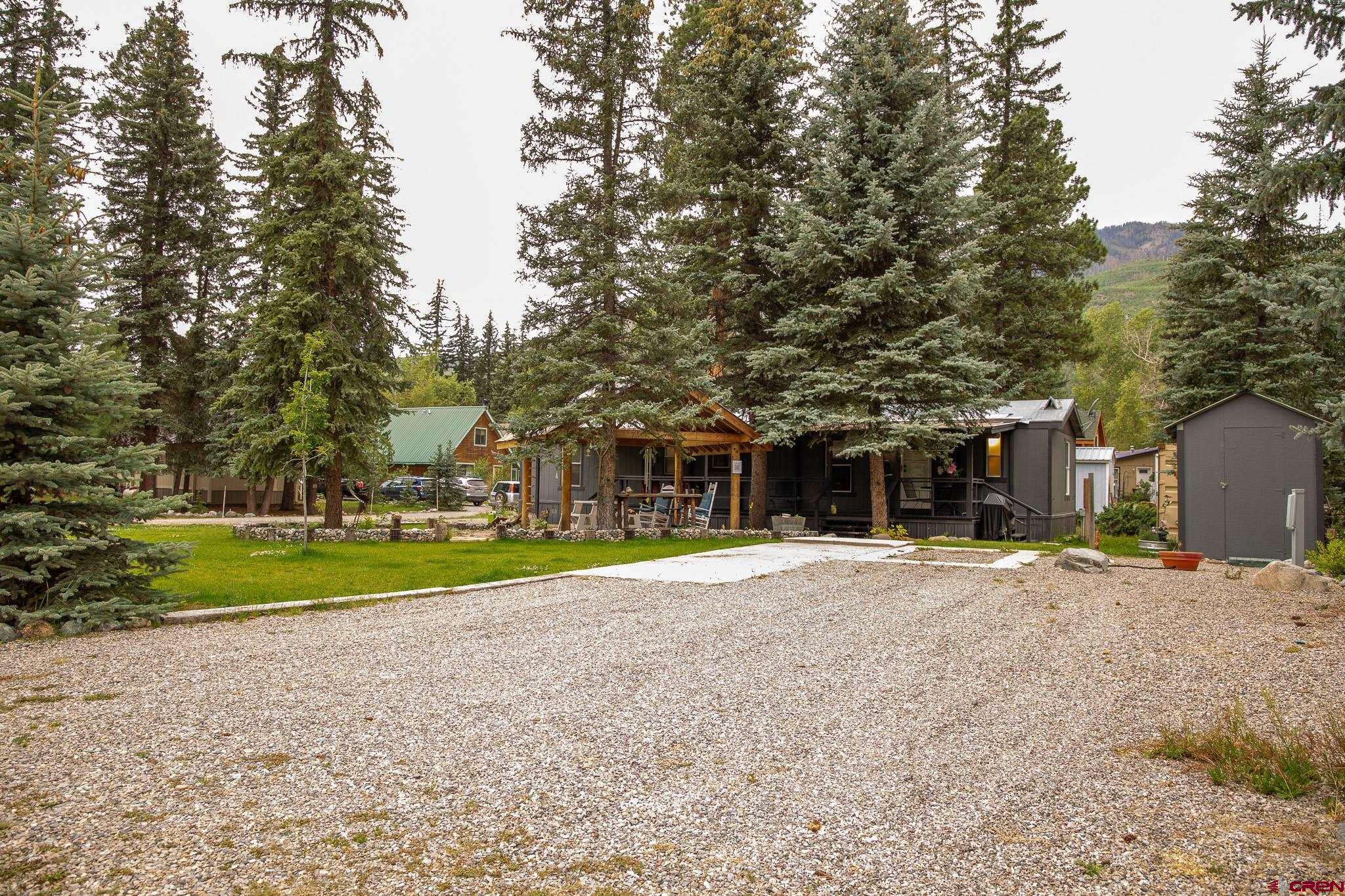 263 Mountain River Drive Bayfield, CO 81122 - Photo 19 of 21 a view of a house with a big yard and large trees