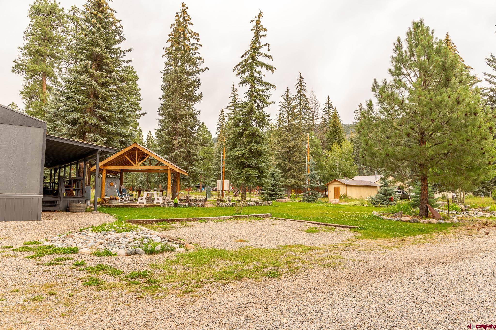 263 Mountain River Drive Bayfield, CO 81122 - Photo 21 of 21 a front view of a house with a yard and trees