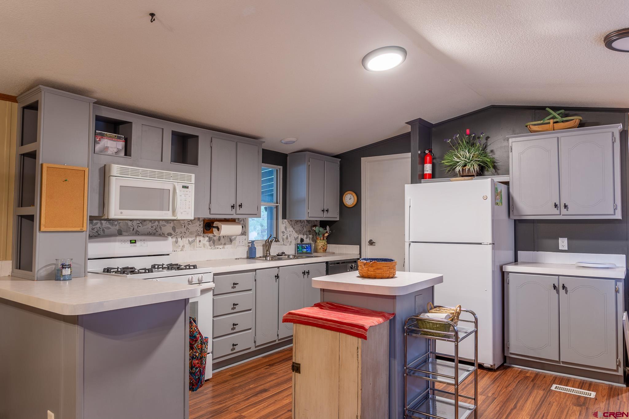 263 Mountain River Drive Bayfield, CO 81122 - Photo 5 of 21 a kitchen with a sink a stove a refrigerator and cabinets