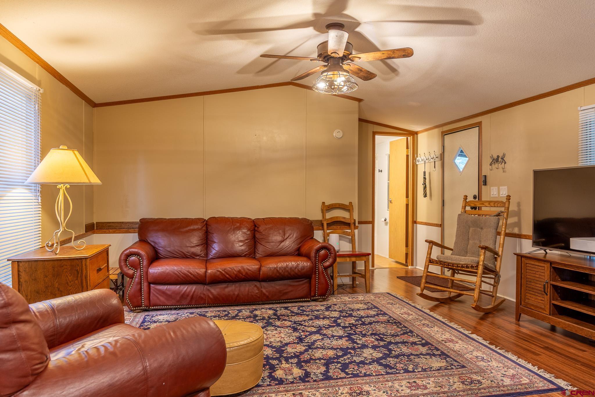 263 Mountain River Drive Bayfield, CO 81122 - Photo 7 of 21 a living room with a couch and a flat screen tv