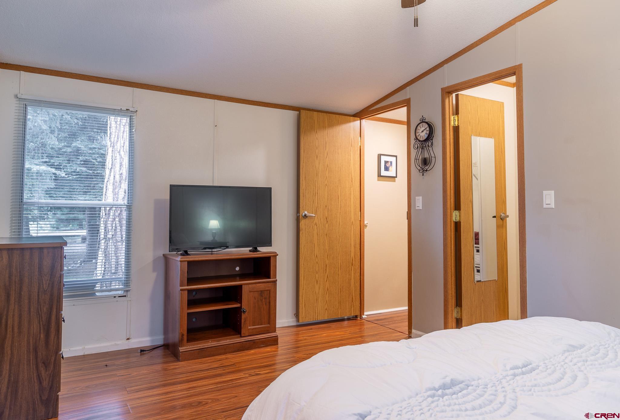 263 Mountain River Drive Bayfield, CO 81122 - Photo 9 of 21 a bedroom with a bed and a flat screen tv