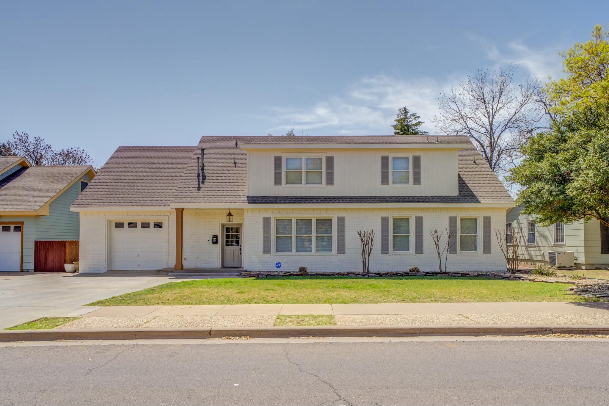 3219 22nd Street Lubbock, TX 79410 - Photo 1 of 51 a view of a white house with a large trees