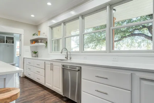 a kitchen with sink cabinets and window